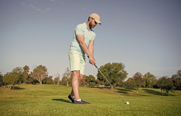 Mature male golf player on professional course with green grass\
golf course