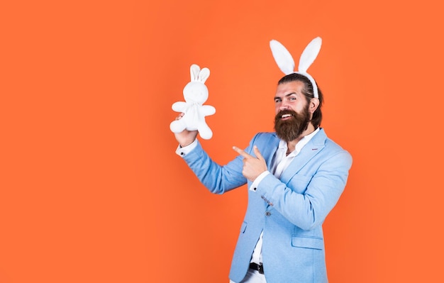 Foto maschio maturo indossare orecchie di coniglio coniglietto pasquale uomo buona pasqua uomo barbuto indossare orecchie da coniglio caccia all'uovo festa di primavera celebrazione divertente maschio hipster uomo brutale divertirsi coniglietti pasquali