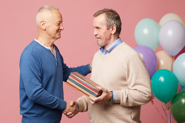 Mature man accepting birthday congratulations