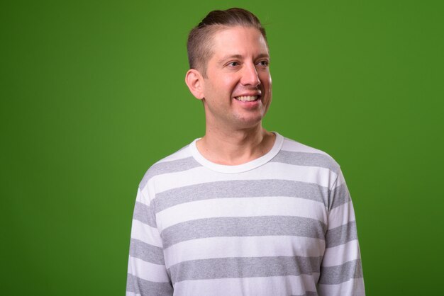 Mature man against green background