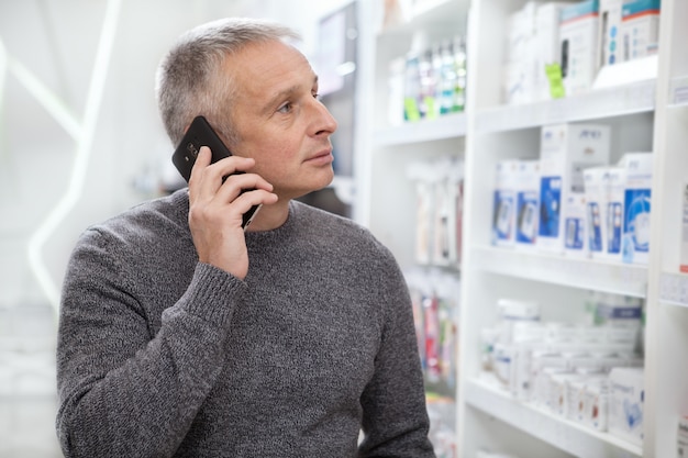 Mature man buying medications at the drugstore