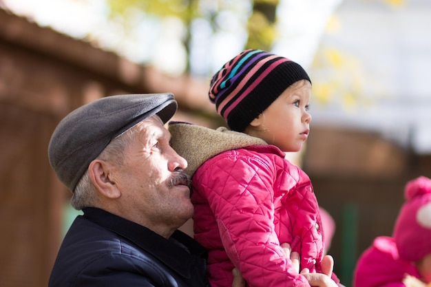 Mature man and cute little girl looking at something attentively outside