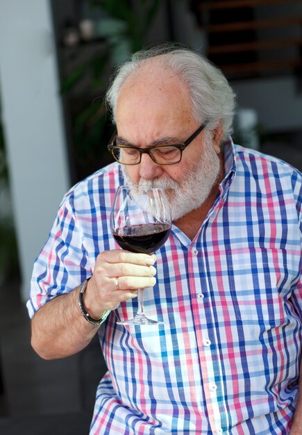 Photo mature man drinking wine