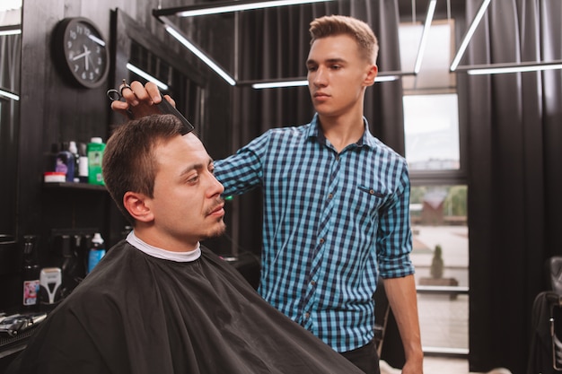 Mature man getting a new haircut at the barbershop