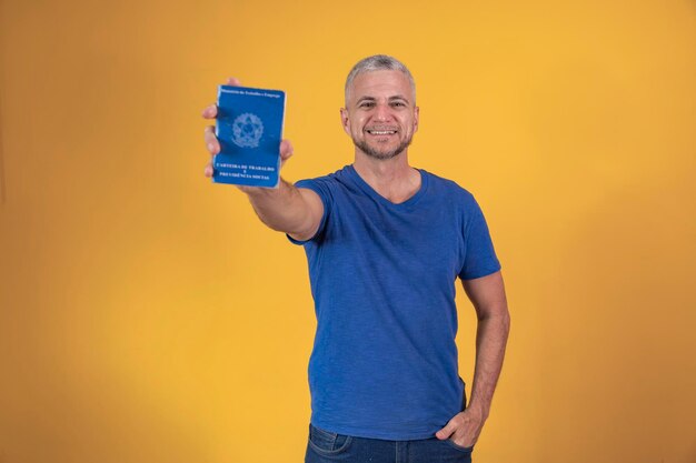 Mature man holding a brazilian work card