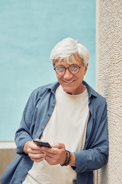 Mature Man Holding Smartphone Minimal