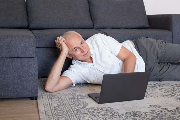 Mature man at home during online business meeting or webinar