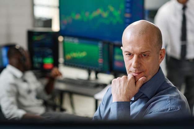 Mature man looking at monitor