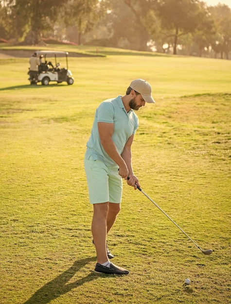 Mature man playing golf game on green grass golf swing