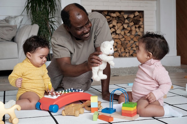 Mature man playing with babies