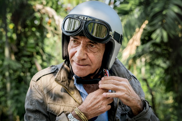 Mature man putting on a helmet