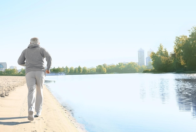 Mature man running near river