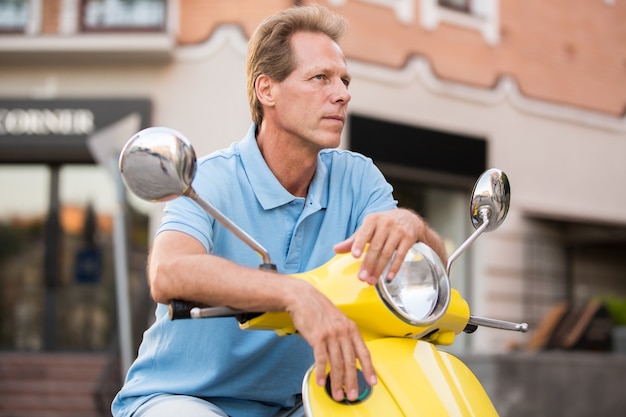 Mature man on a scooter.