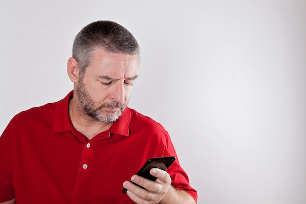 Mature man searching for information in cell phone