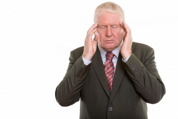 Mature man in suit with headache