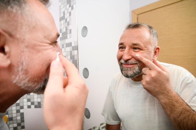 Mature man taking care of his skin