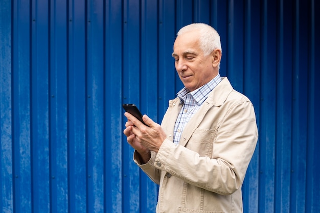 Mature man using smartphone