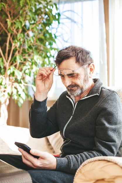 Mature man using smartphone