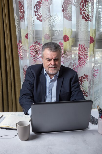 Mature man with a beard working at home