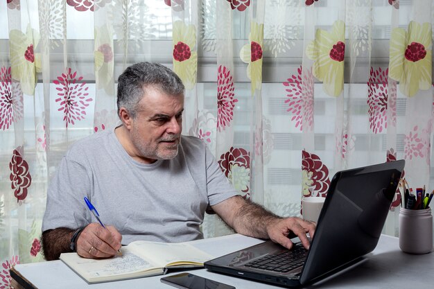 Mature man with a beard working at home