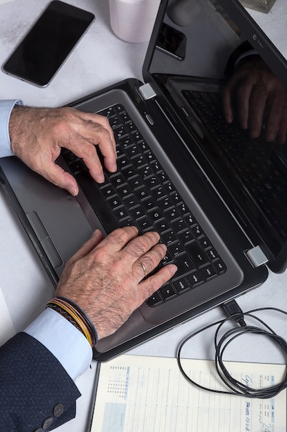 Mature man with a beard working at home