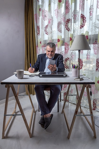 Mature man with a beard working at home