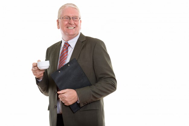 Mature man with a clipboord and a cup of coffee