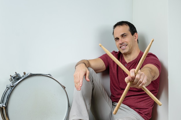 Mature man with a drum and sticks