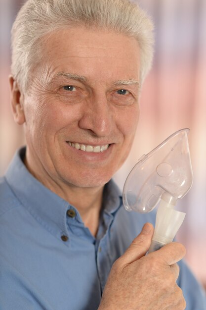 Mature man with oxygen mask, close up