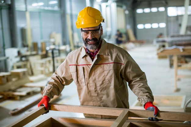 mature man working in furniture factory