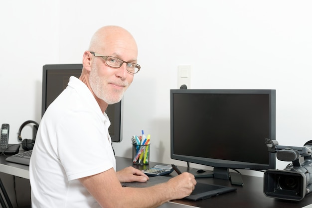 Mature man working with his computer