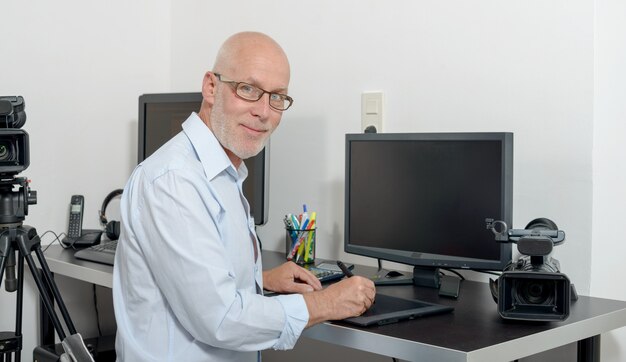 Mature man working with his computer