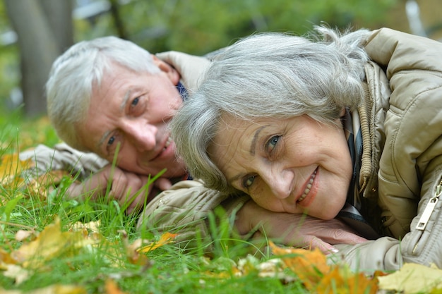 Mature married couple having fun on fresh air in autumn