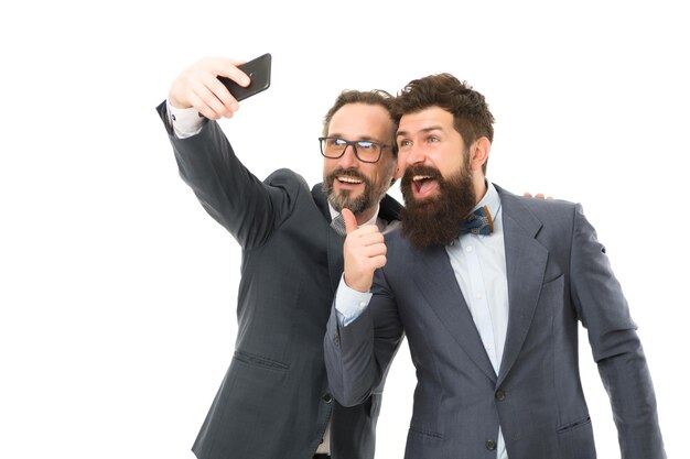 Mature men making selfie Agile business collaboration and teamwork partnership of men speaking on phone bearded businessmen in formal suit business communication on meeting team success