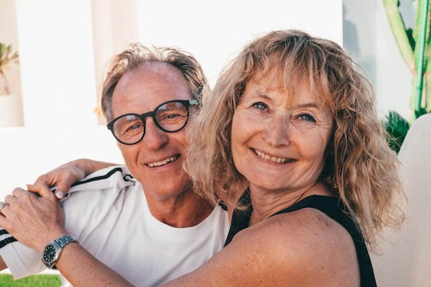 Mature middle aged family couple smiling embracing getting closer enjoying moment of affection