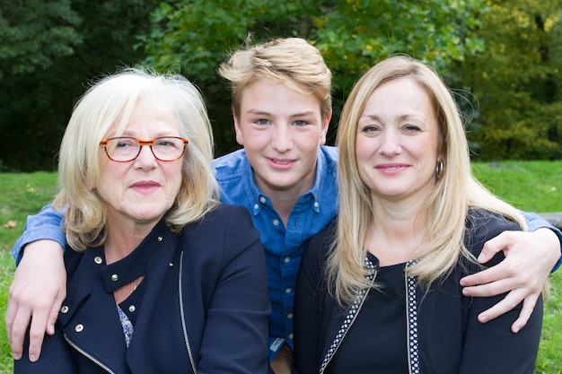 Mature mother and daughter with grand son outside