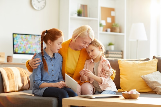 Mature Mother Embracing Two Girls