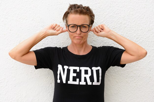 Photo mature nerd woman wearing big eyeglasses and standing isolated