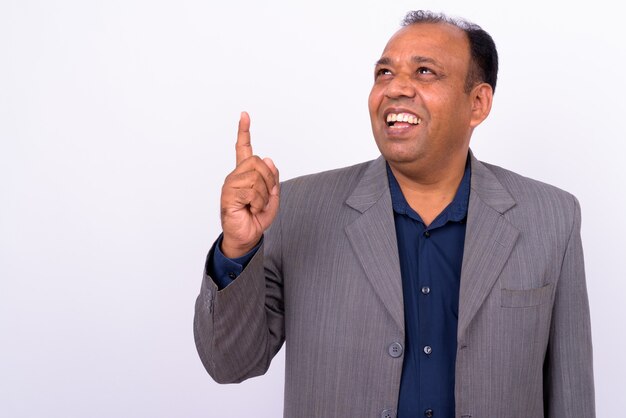 mature overweight Indian businessman in suit with receding hairline on white