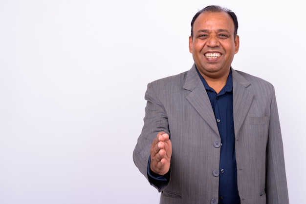 mature overweight Indian businessman in suit with receding hairline on white