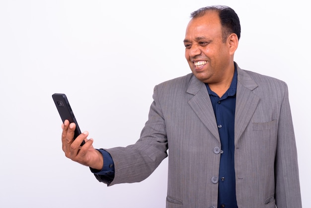 mature overweight Indian businessman in suit with receding hairline on white