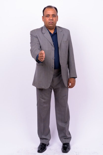 mature overweight Indian businessman in suit with receding hairline on white