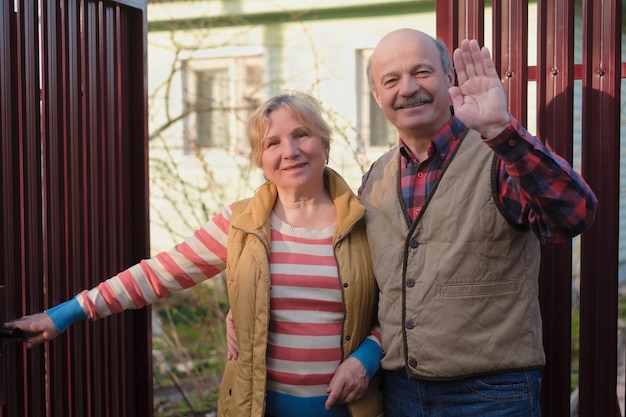 Mature parents meeting their children waving hands