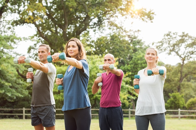 Mature people exercise at park