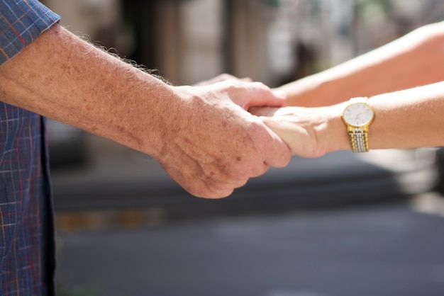 Mature people romantic holding hands