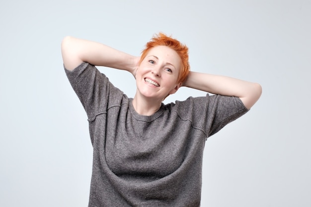 Mature redhead woman in a gray blouse