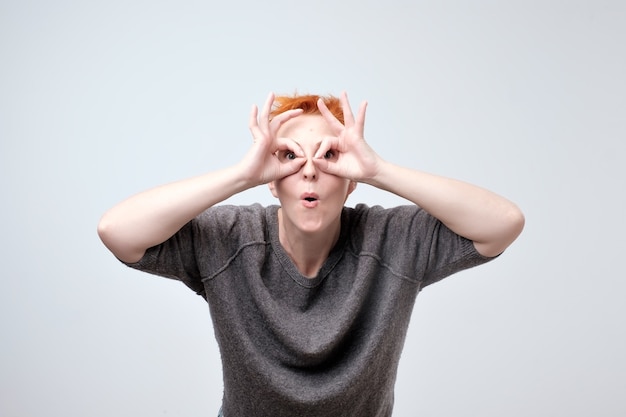 mature redhead woman in a gray blouse