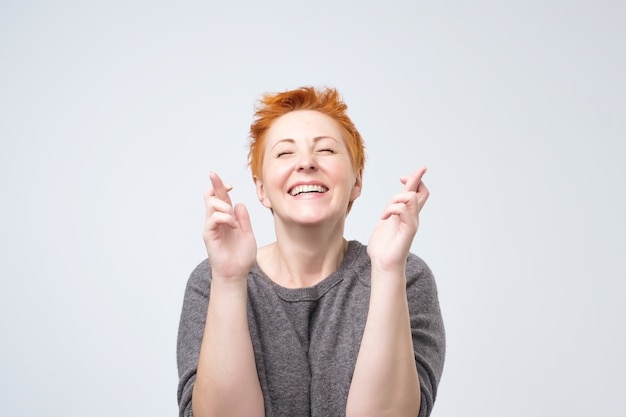 Mature redhead woman in a gray blouse