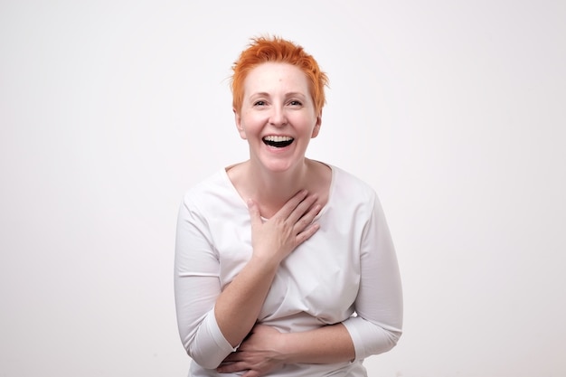 Mature redhead woman in a white shirt