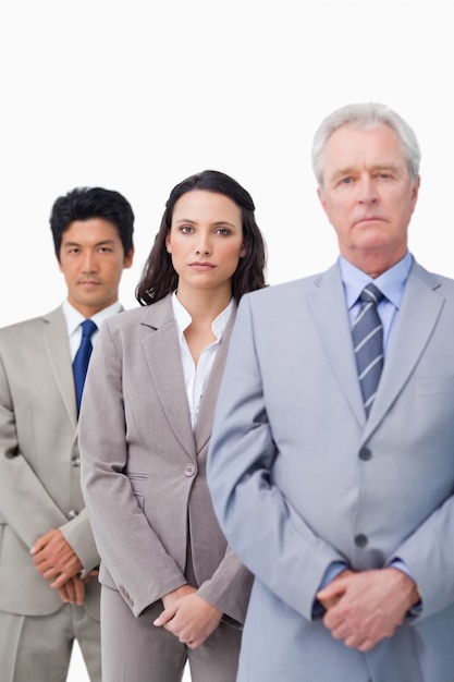 Mature salesman standing with his young employees